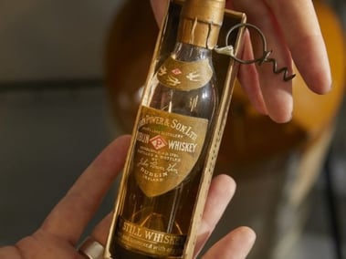 miniature bottle of whiskey - baby powers - irish whiskey